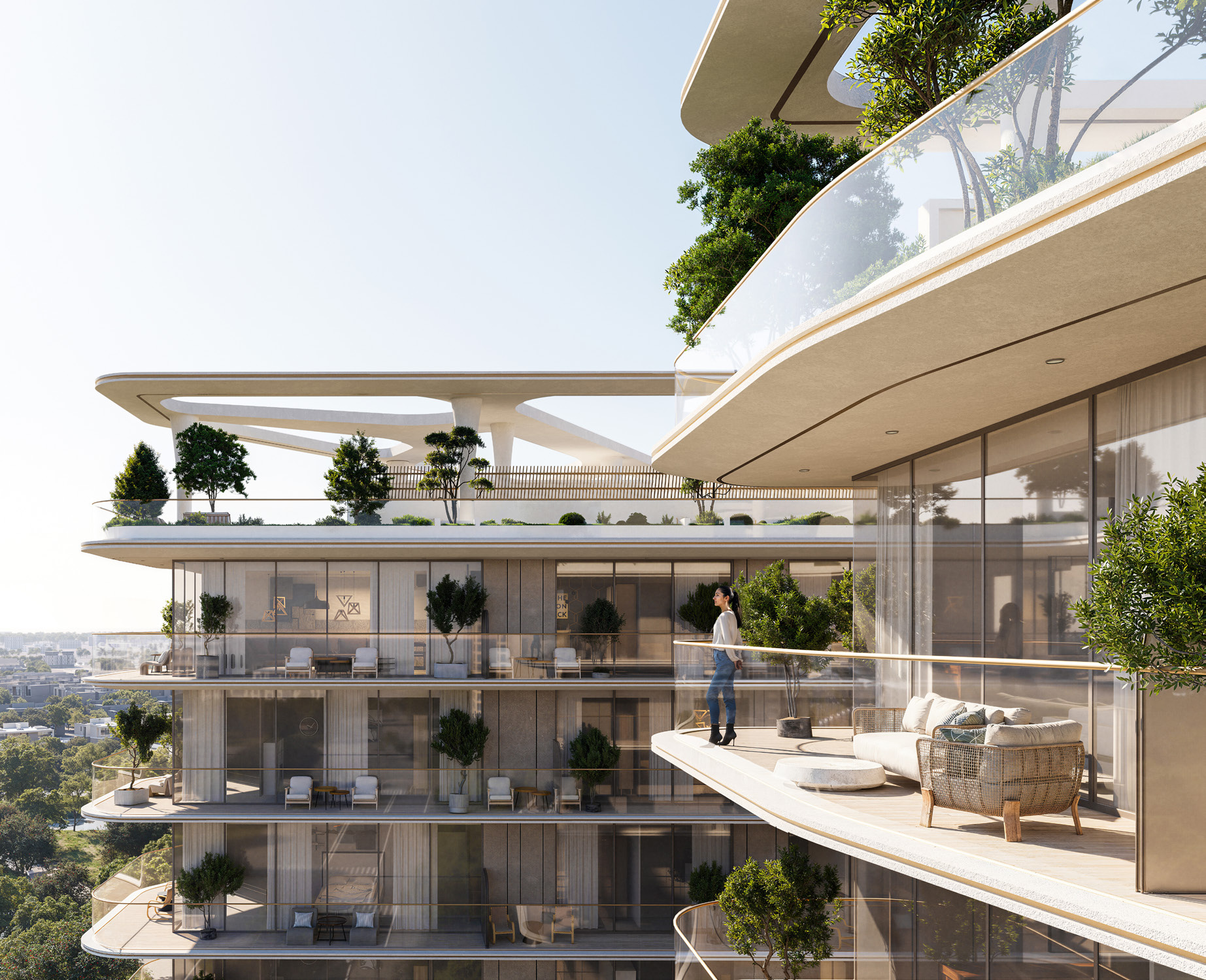 Vista cercana de los balcones curvos, las fachadas de vidrio y la vegetación integrada de Enrè Residence.