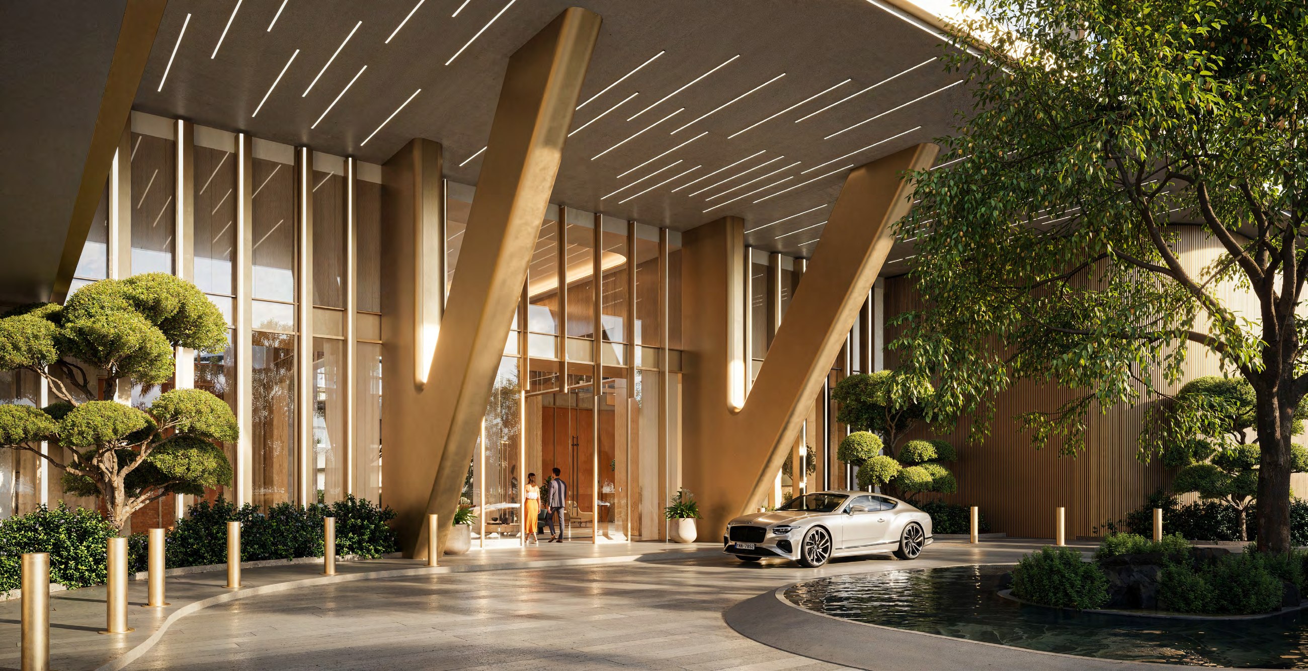 Covered HADO drop-off with angled columns, landscaped planting and water feature.