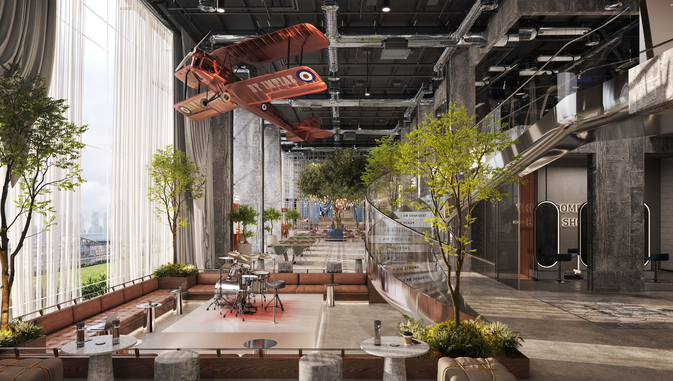 Large double-height indoor community space with trees, cafe seating and an art installation.
