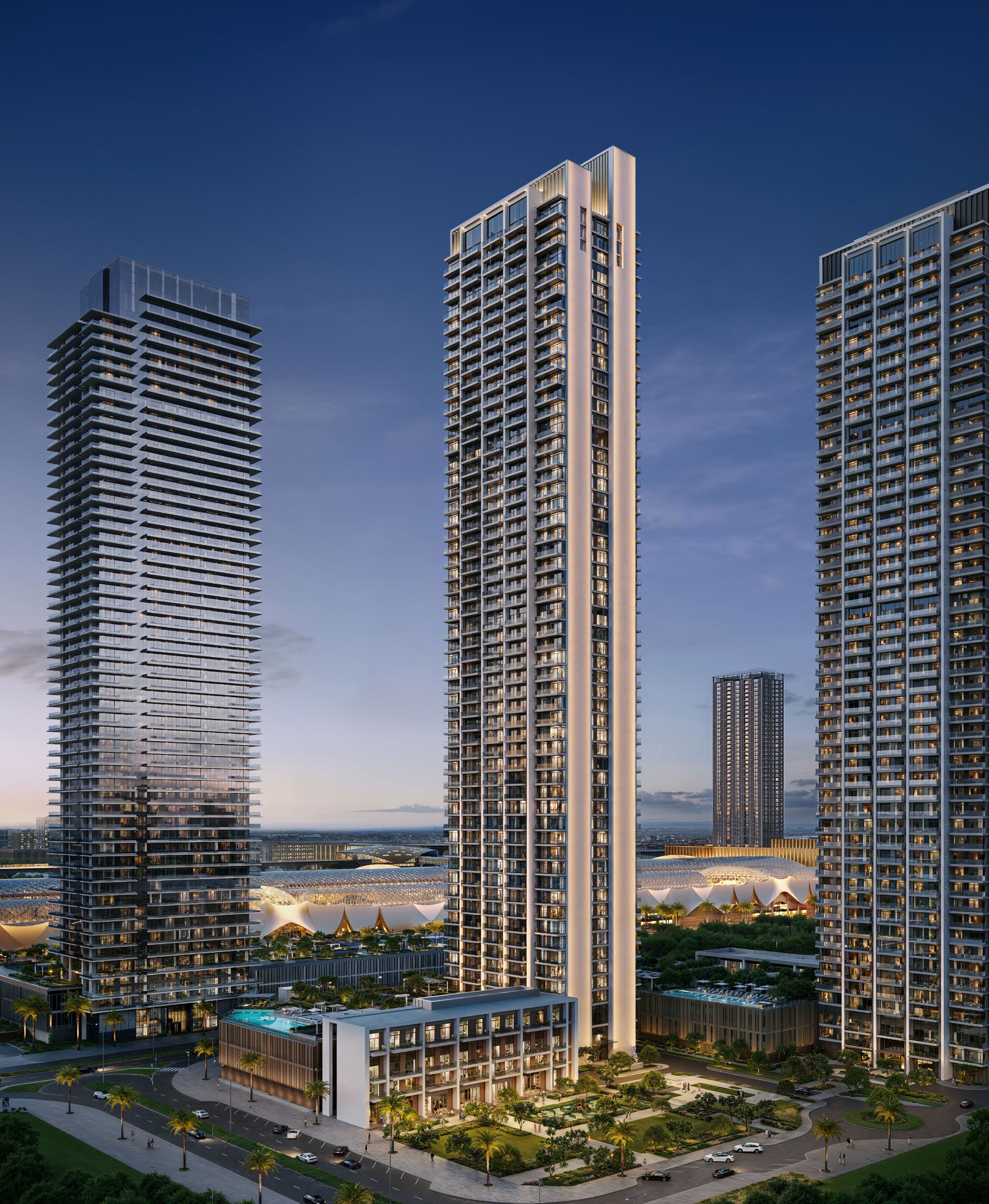 Torre residencial Valia elevándose sobre su podio ajardinado de uso mixto